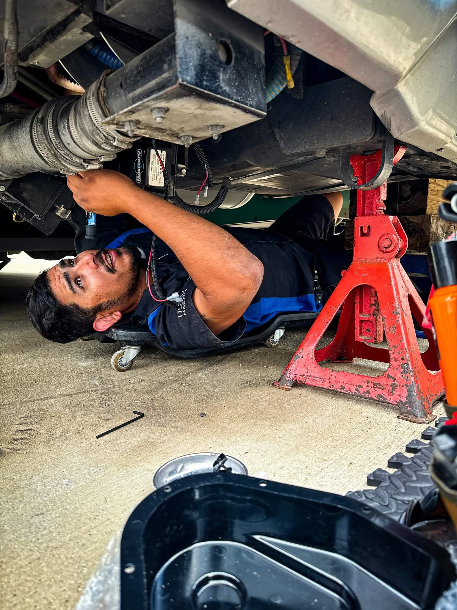 Blue Moon RV technician Adrian performing hands-on diagnostics inside a motorhome service bay