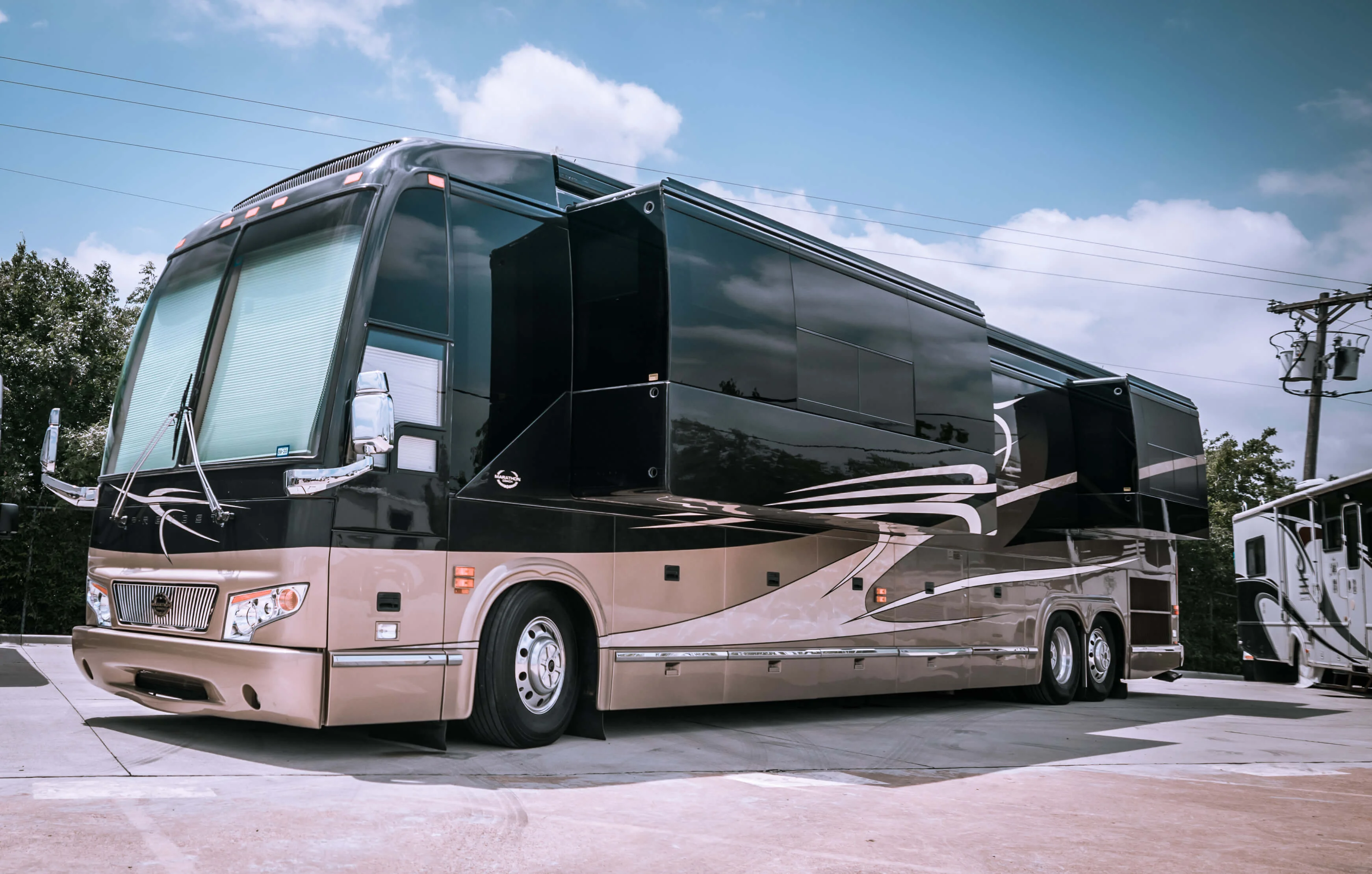 Luxury motorhome parked with slide-outs extended during service preparation at Blue Moon Mobile RV