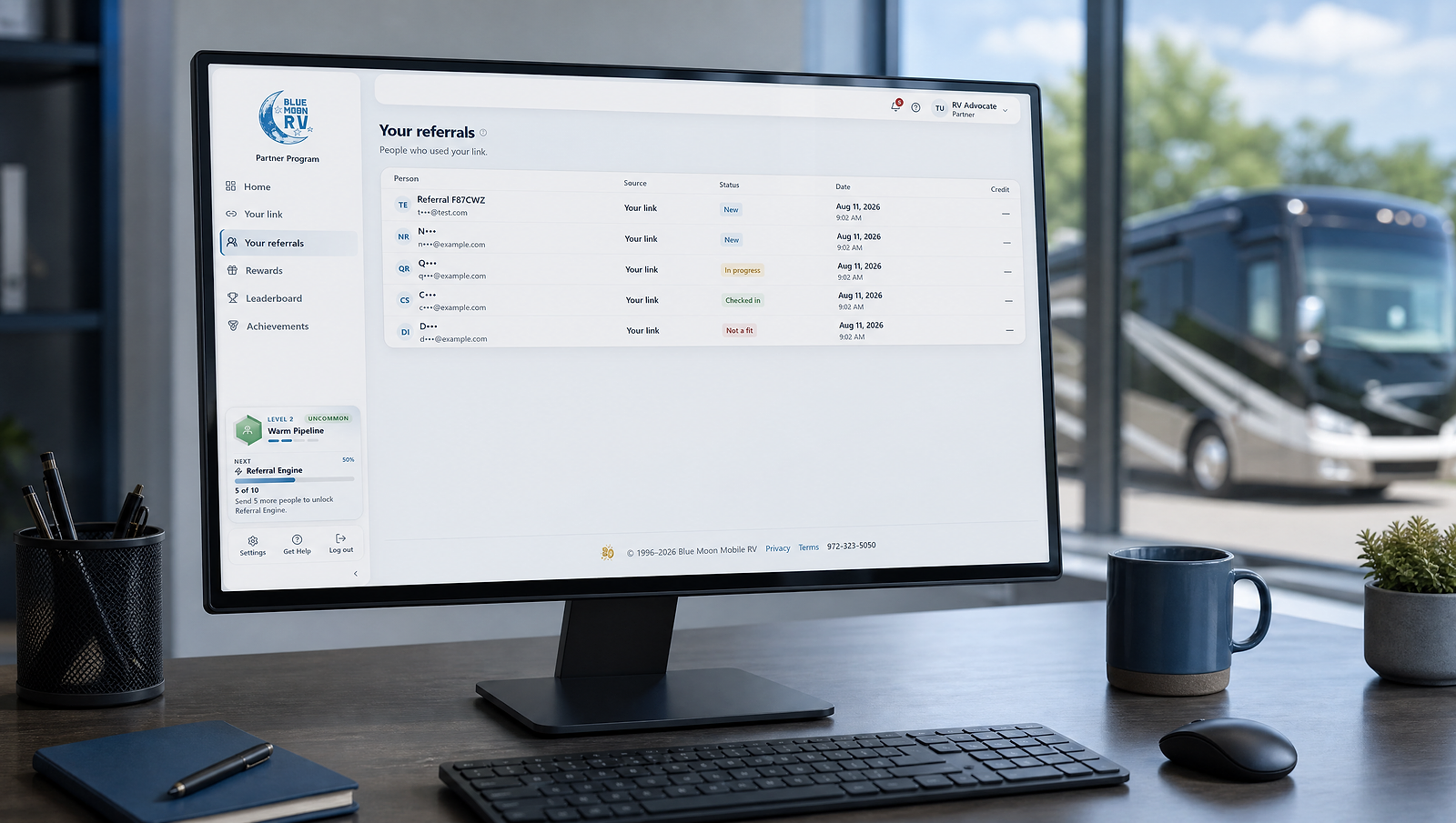 Blue Moon referral activity dashboard displayed on a desktop monitor in an RV service office